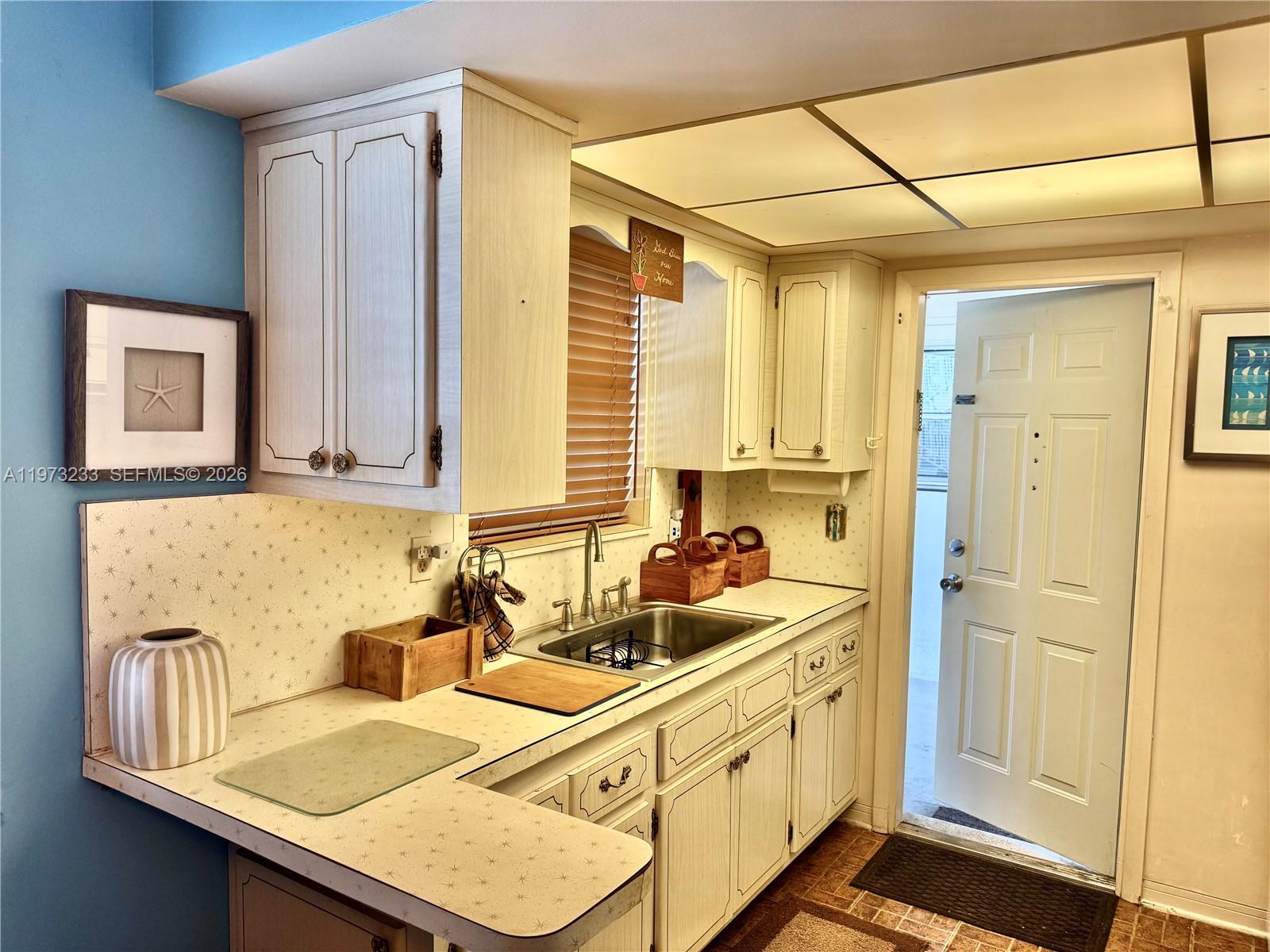 3500 Harrison Street, Unit 7 Hollywood, FL 33021 - Photo 4 of 66 a bathroom with a sink and a mirror