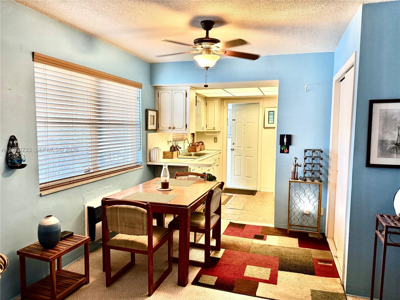 3500 Harrison Street, Unit 7 Hollywood, FL 33021 - Photo 5 of 66 a dining room with stainless steel appliances kitchen island granite countertop furniture and a chandelier