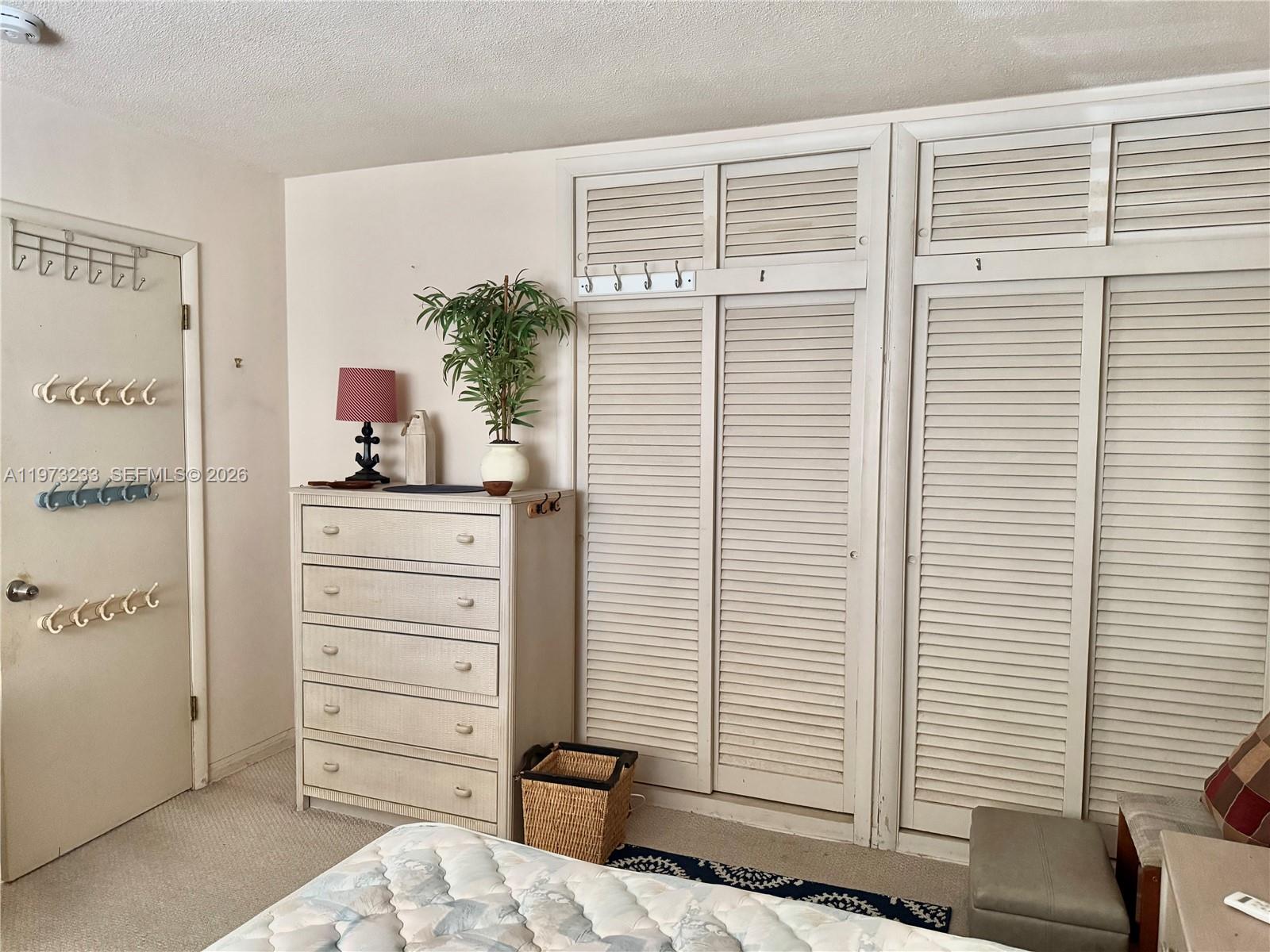 3500 Harrison Street, Unit 7 Hollywood, FL 33021 - Photo 58 of 66 a view of a bedroom with a window and cabinet