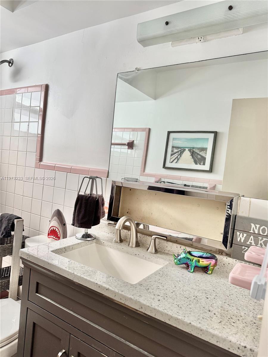 3500 Harrison Street, Unit 7 Hollywood, FL 33021 - Photo 63 of 66 a bedroom with a bed and gym equipment