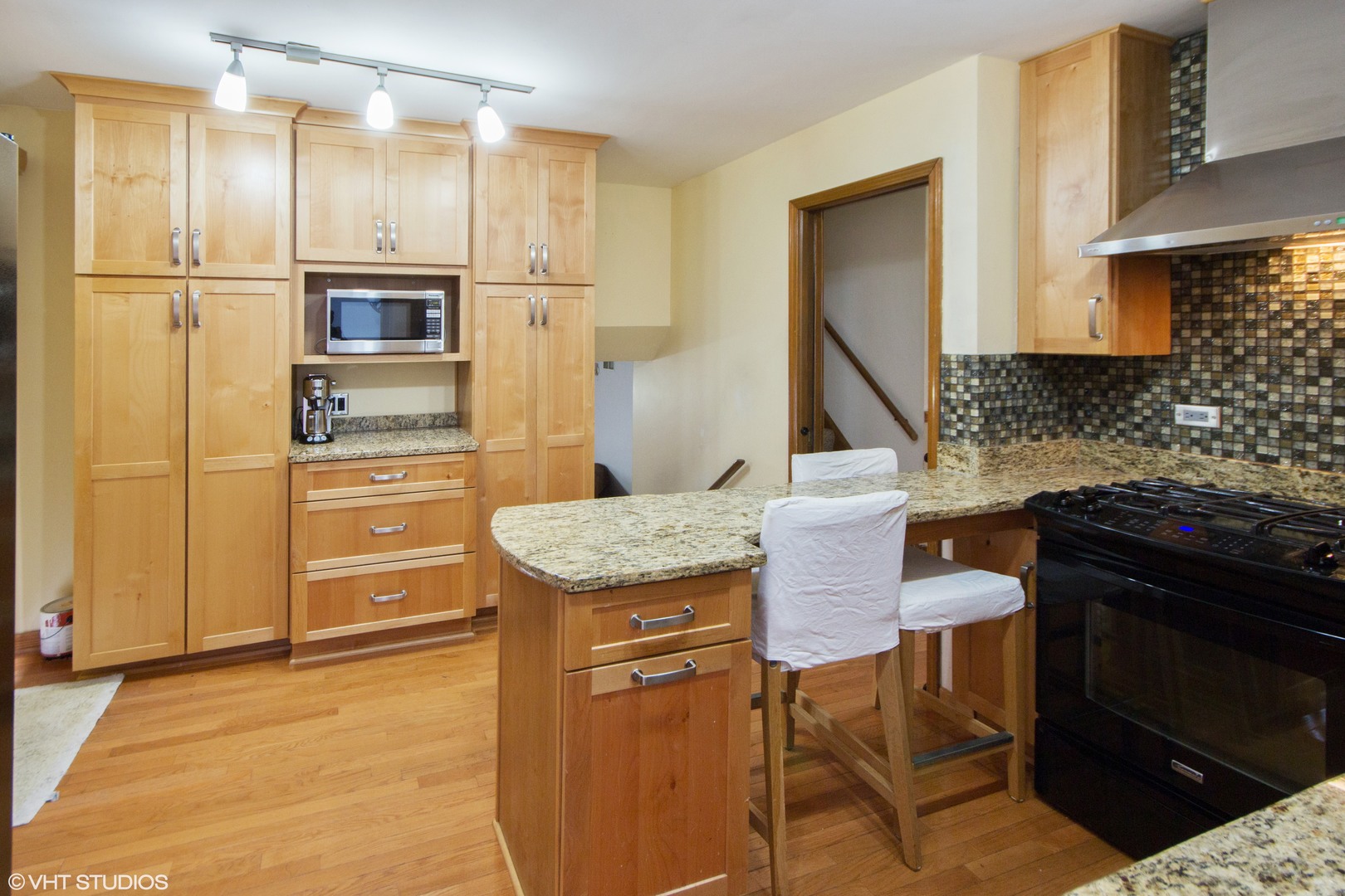 414 South Raven Road Shorewood, IL 60404 - Photo 4 of 15 a kitchen with stainless steel appliances granite countertop a stove refrigerator and cabinets