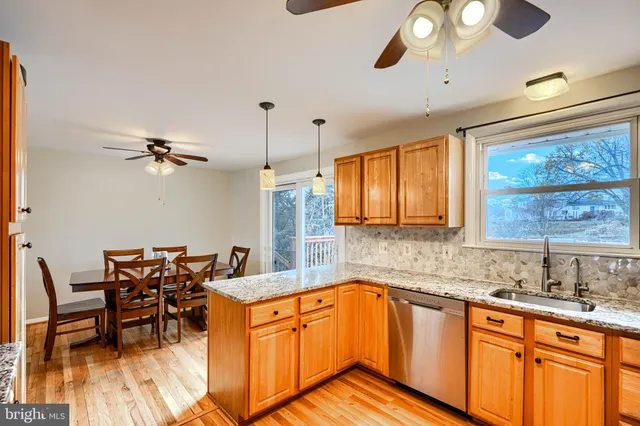 a kitchen with stainless steel appliances granite countertop a sink and cabinets