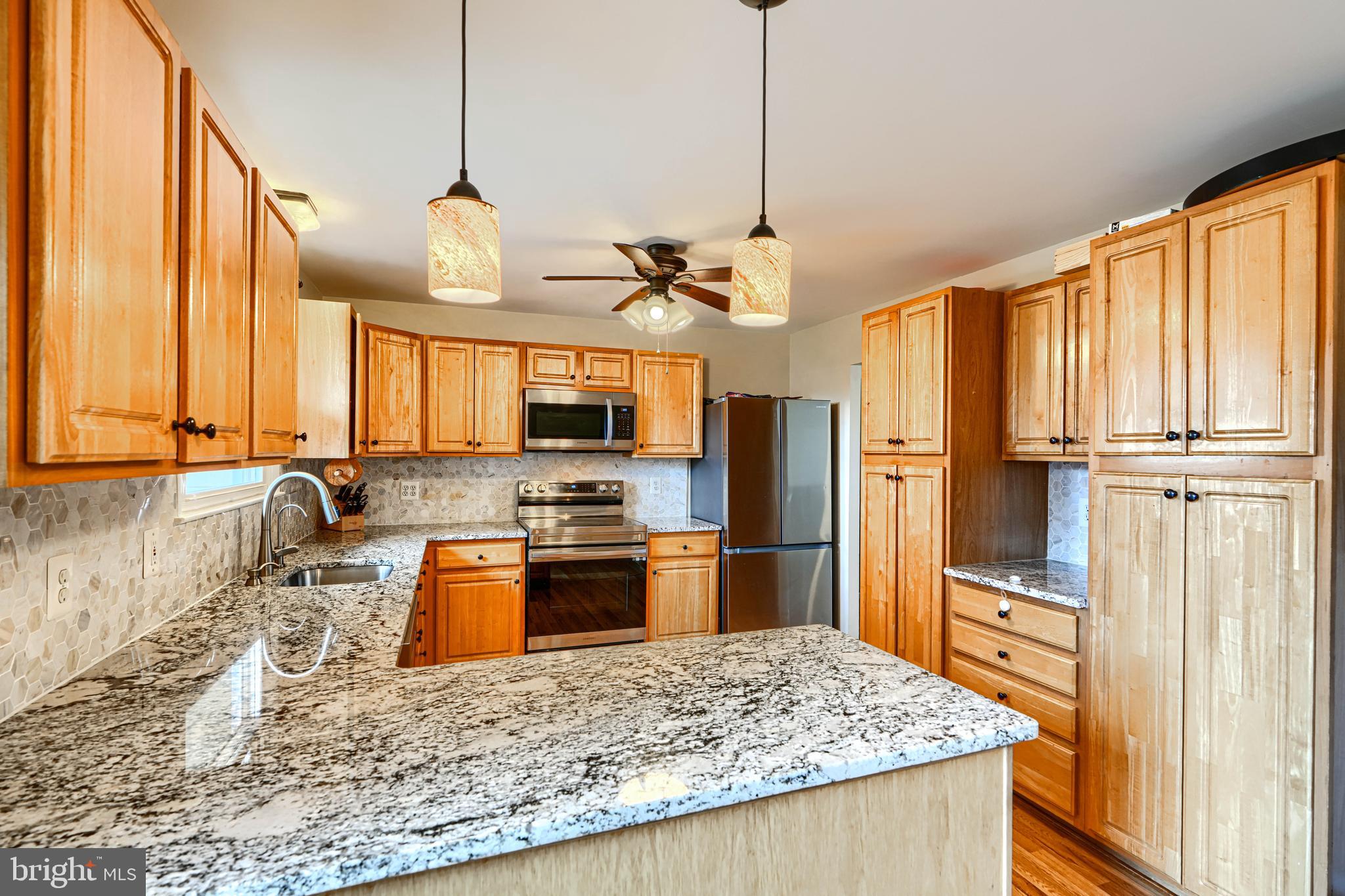 2110 Folkstone Road Lutherville-Timonium, MD 21093 - Photo 13 of 49 a kitchen with stainless steel appliances granite countertop a sink a stove and a refrigerator