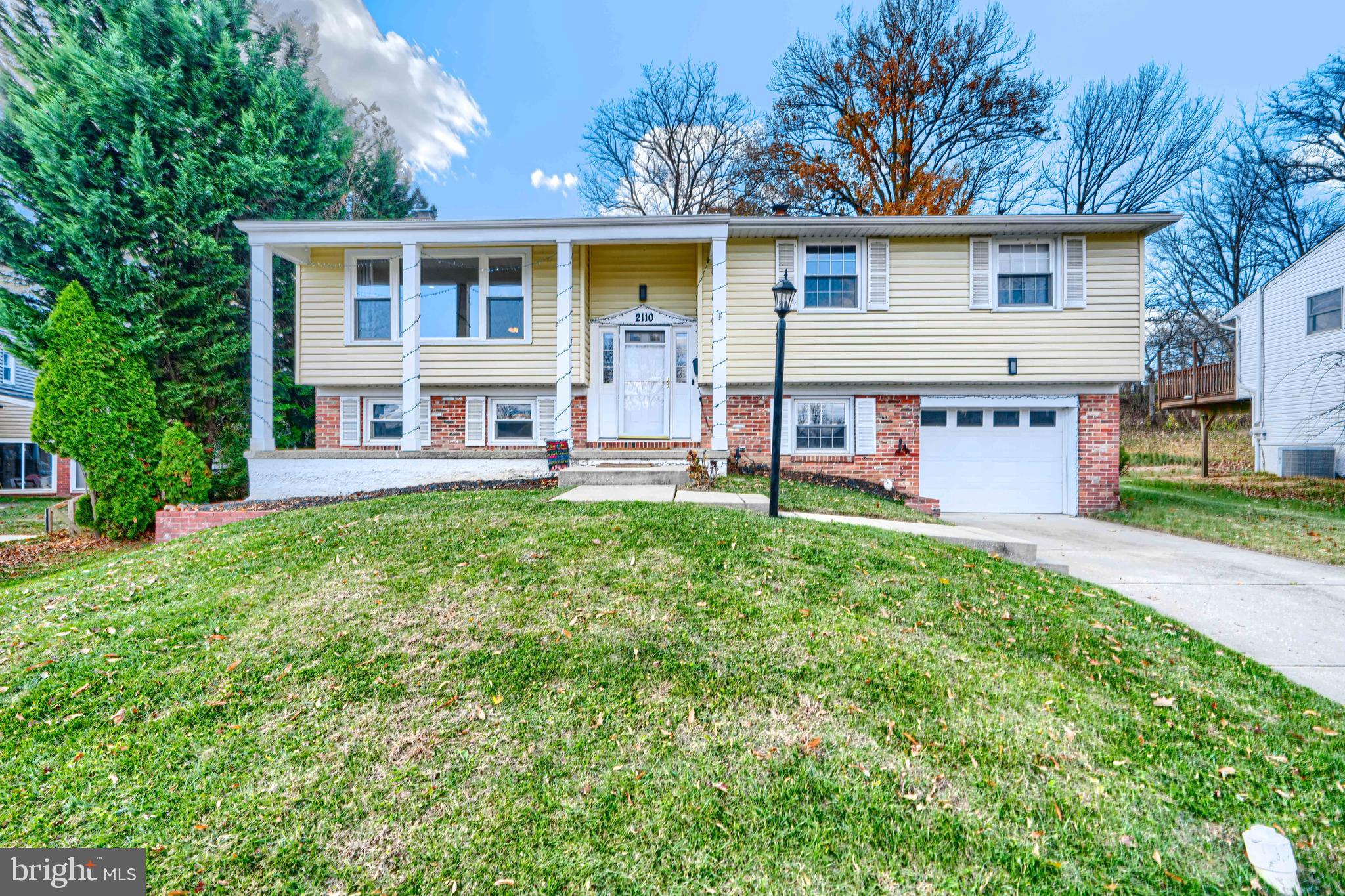 2110 Folkstone Road Lutherville-Timonium, MD 21093 - Photo 2 of 49 a front view of a house with a yard and trees
