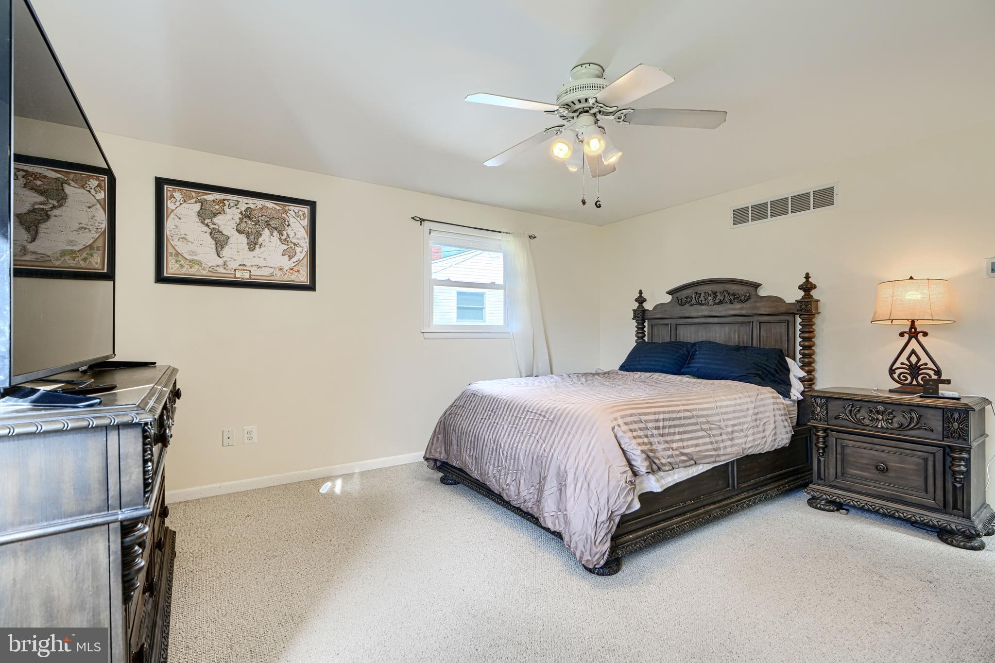 2110 Folkstone Road Lutherville-Timonium, MD 21093 - Photo 22 of 49 a bedroom with a bed and a chandelier