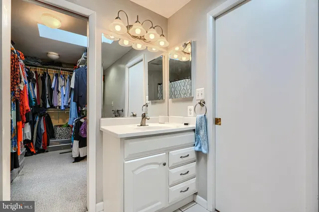 a bathroom with a sink vanity and mirror