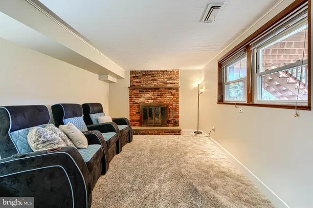 a view of a livingroom with furniture and staircase