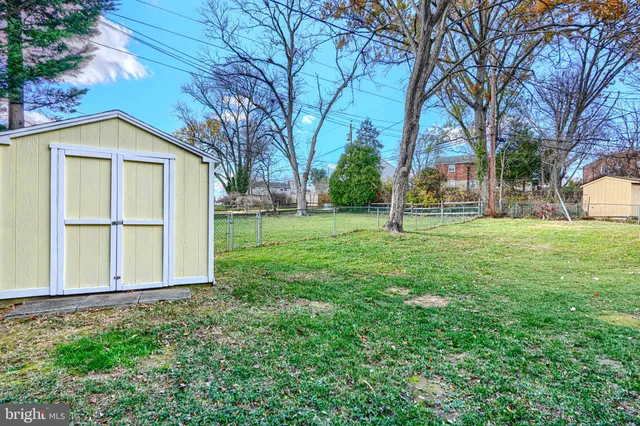 a view of deck with furniture and trees around