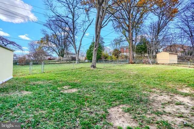 a view of a cafe with a table and chairs under an umbrella