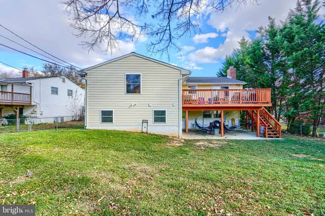 a view of a house with a big yard and large tree