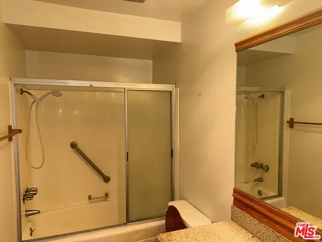 a bathroom with a shower and a sink