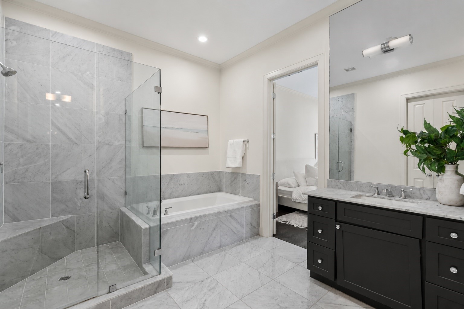 908 Thompson Street Houston, TX 77007 - Photo 22 of 45 This elegant bathroom features a spacious glass-enclosed shower, a soaking tub, and beautiful marble finishes throughout.