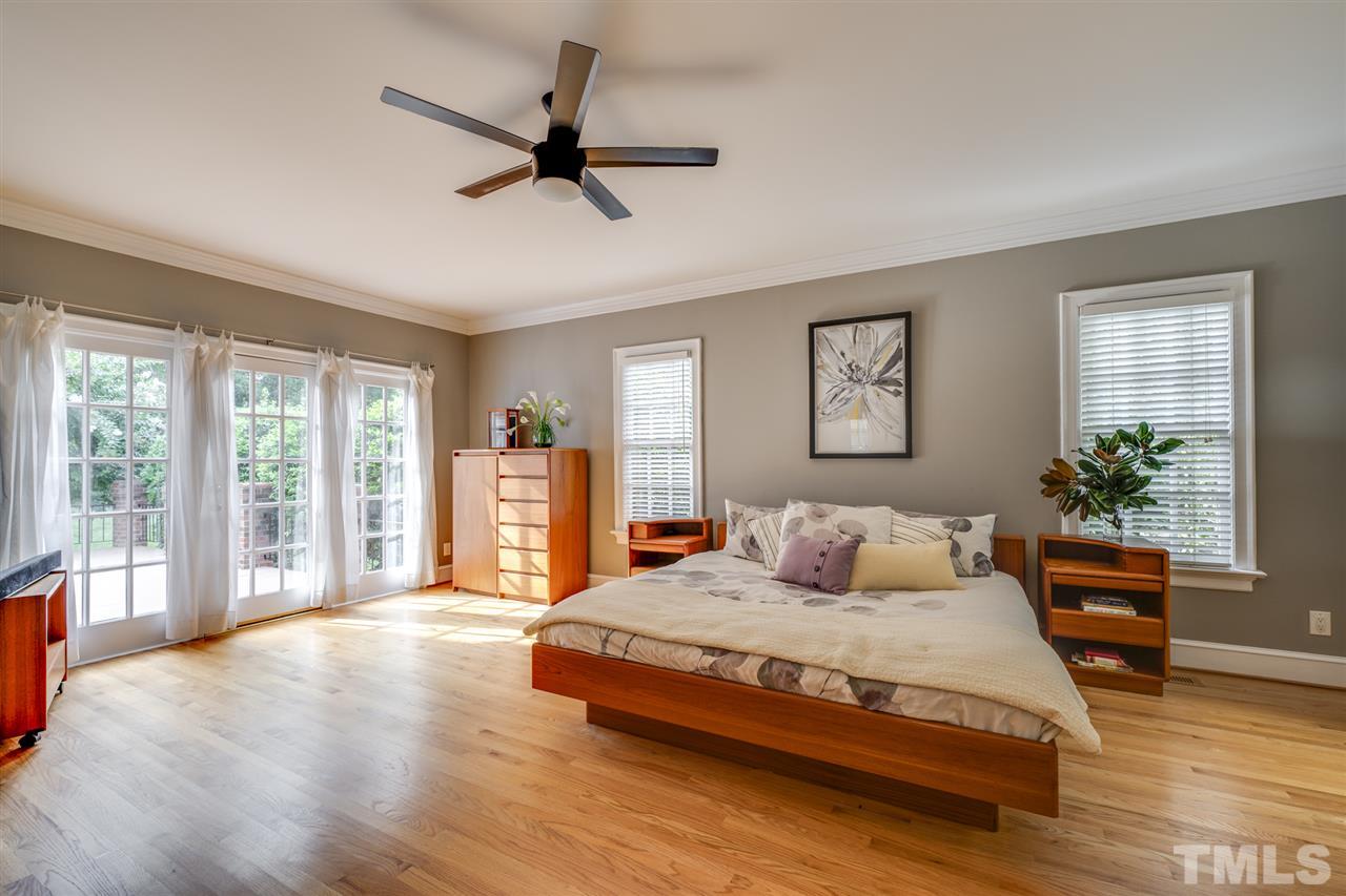 4621 White Chapel Way Raleigh, NC 27615 - Photo 15 of 30 a bedroom with a large bed and a large window
