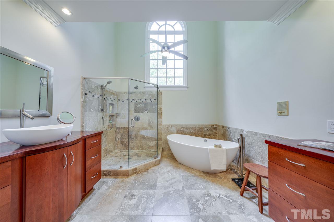 4621 White Chapel Way Raleigh, NC 27615 - Photo 16 of 30 a spacious bathroom with a bathtub sink and mirror