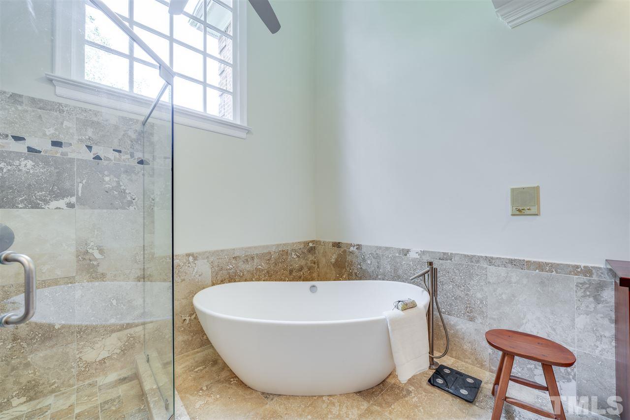 4621 White Chapel Way Raleigh, NC 27615 - Photo 17 of 30 a bathroom with a bathtub and shower