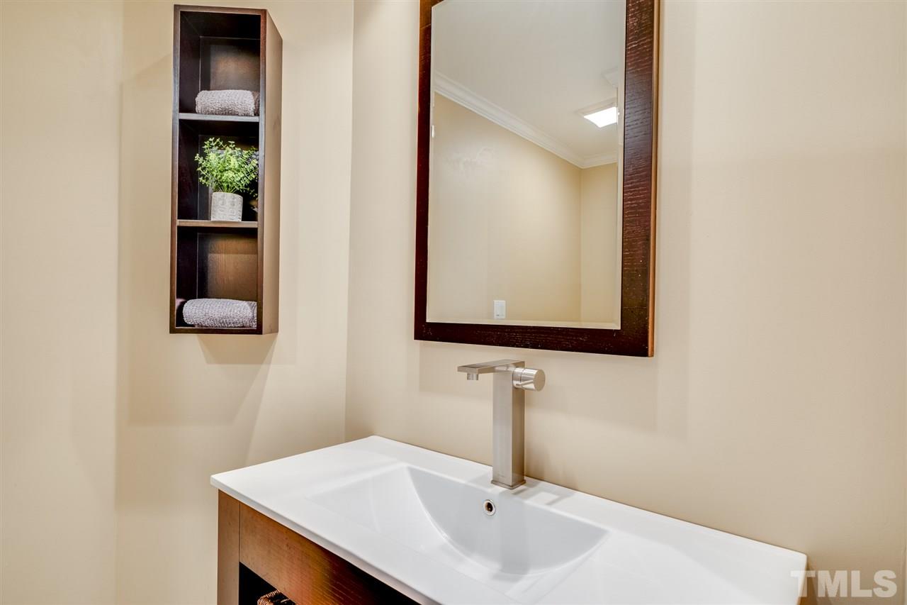 4621 White Chapel Way Raleigh, NC 27615 - Photo 19 of 30 a bathroom with a sink and a mirror