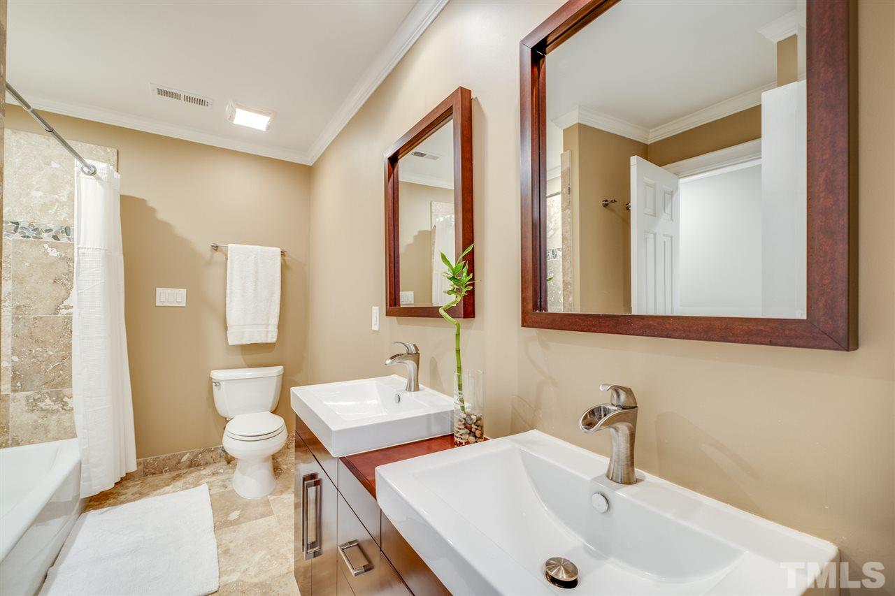 4621 White Chapel Way Raleigh, NC 27615 - Photo 21 of 30 a bathroom with 2 sink and a mirror
