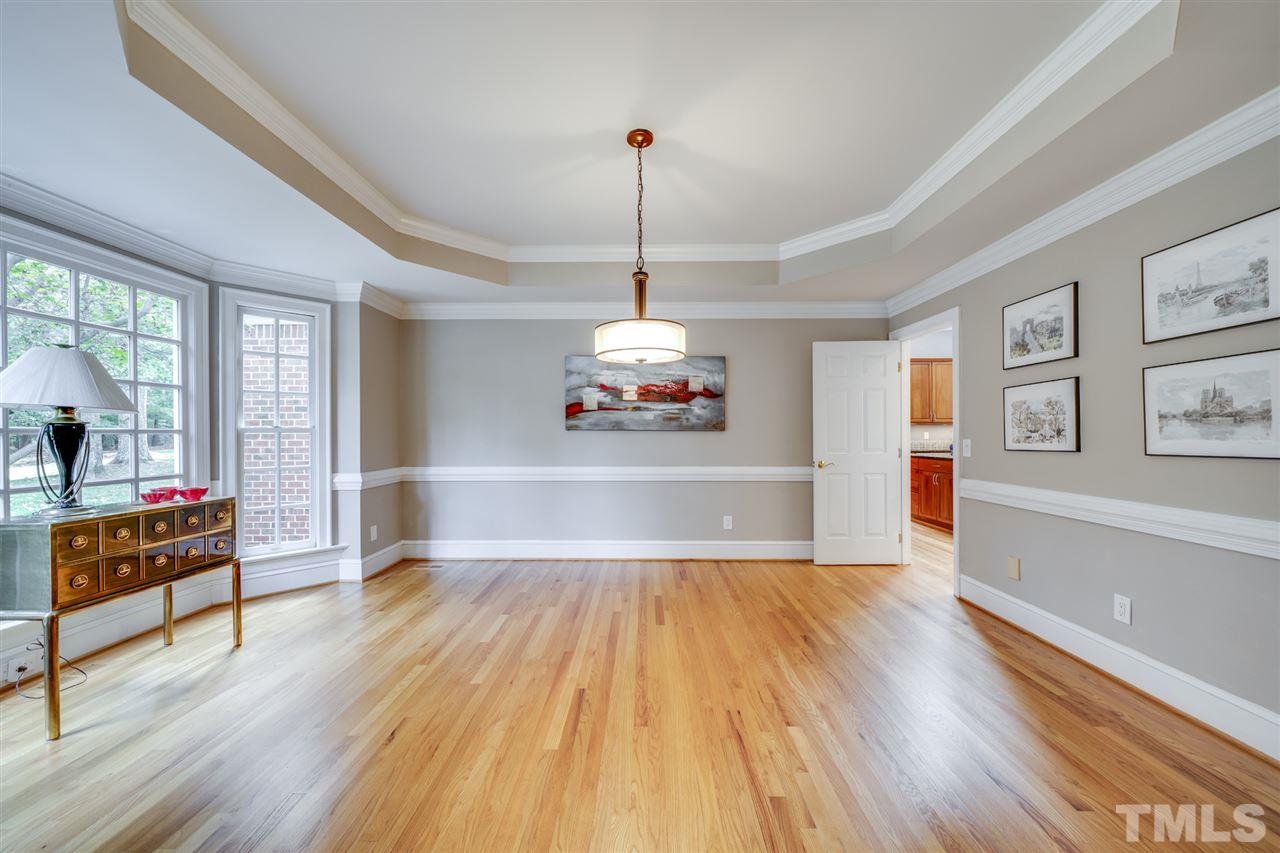 4621 White Chapel Way Raleigh, NC 27615 - Photo 6 of 30 a living room with hard wood floors and a ceiling fan