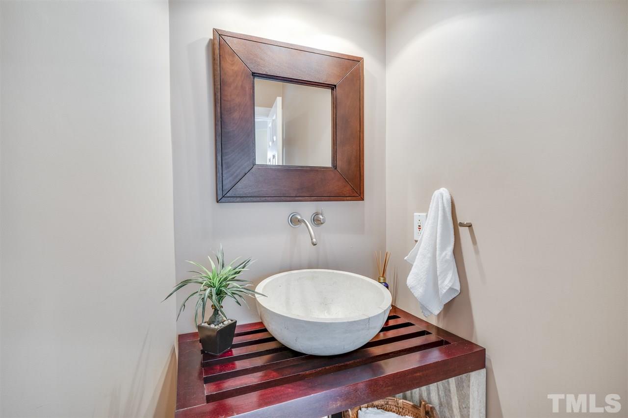 4621 White Chapel Way Raleigh, NC 27615 - Photo 7 of 30 a bathroom with a sink and a mirror