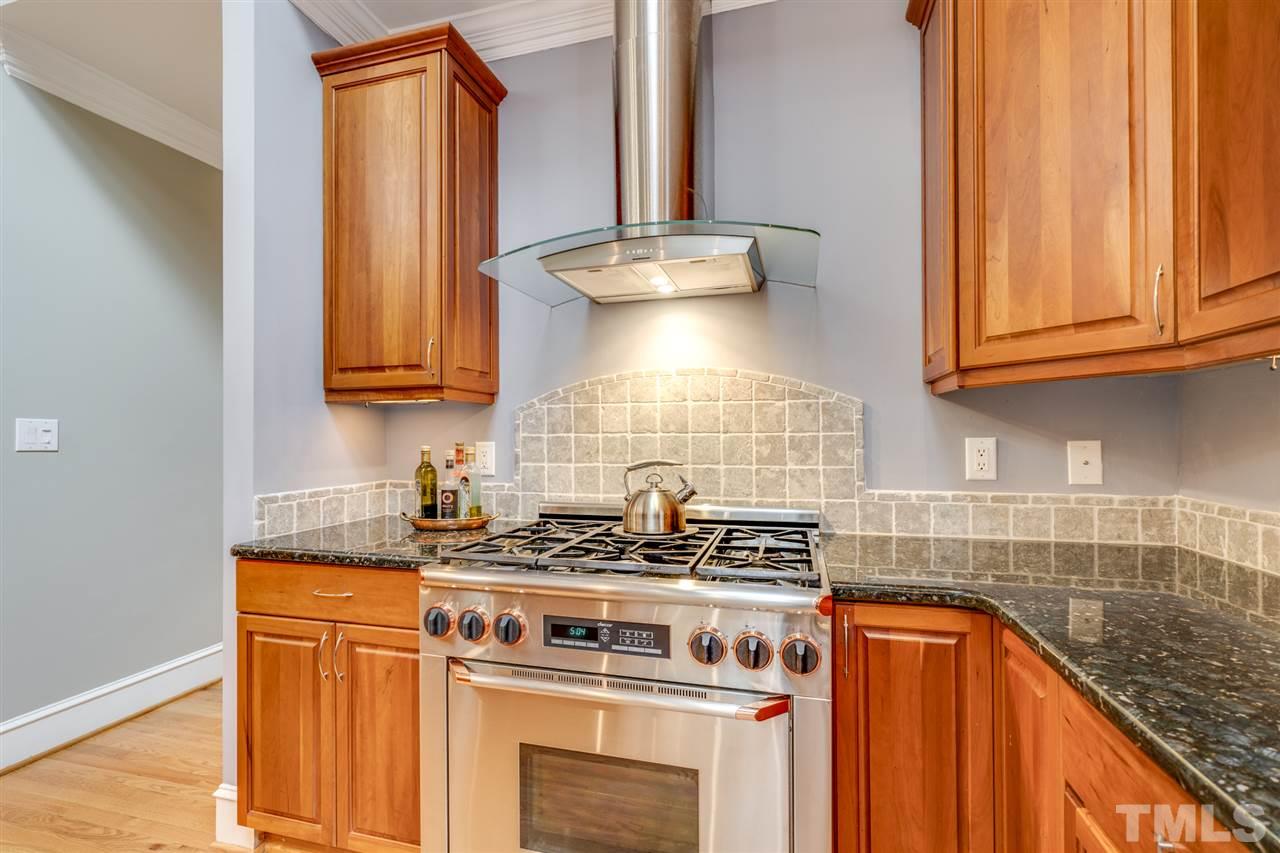 4621 White Chapel Way Raleigh, NC 27615 - Photo 9 of 30 a kitchen with stainless steel appliances granite countertop a stove and a sink
