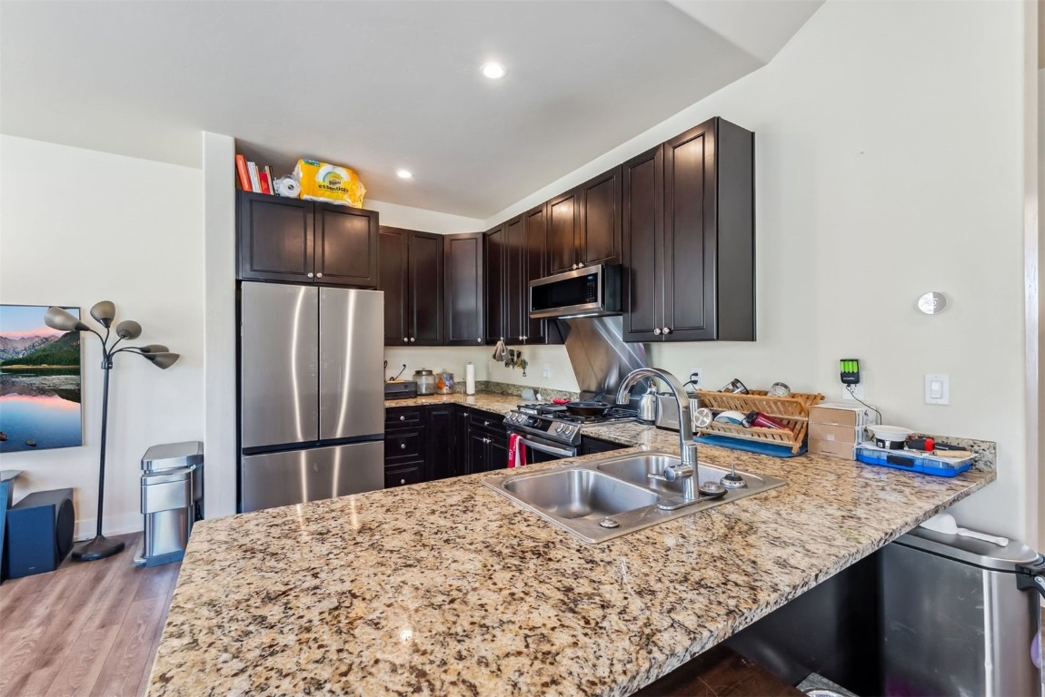 32 Wayback Drive, Unit 32 Keystone, CO 80435 - Photo 12 of 28 a kitchen with sink refrigerator and microwave