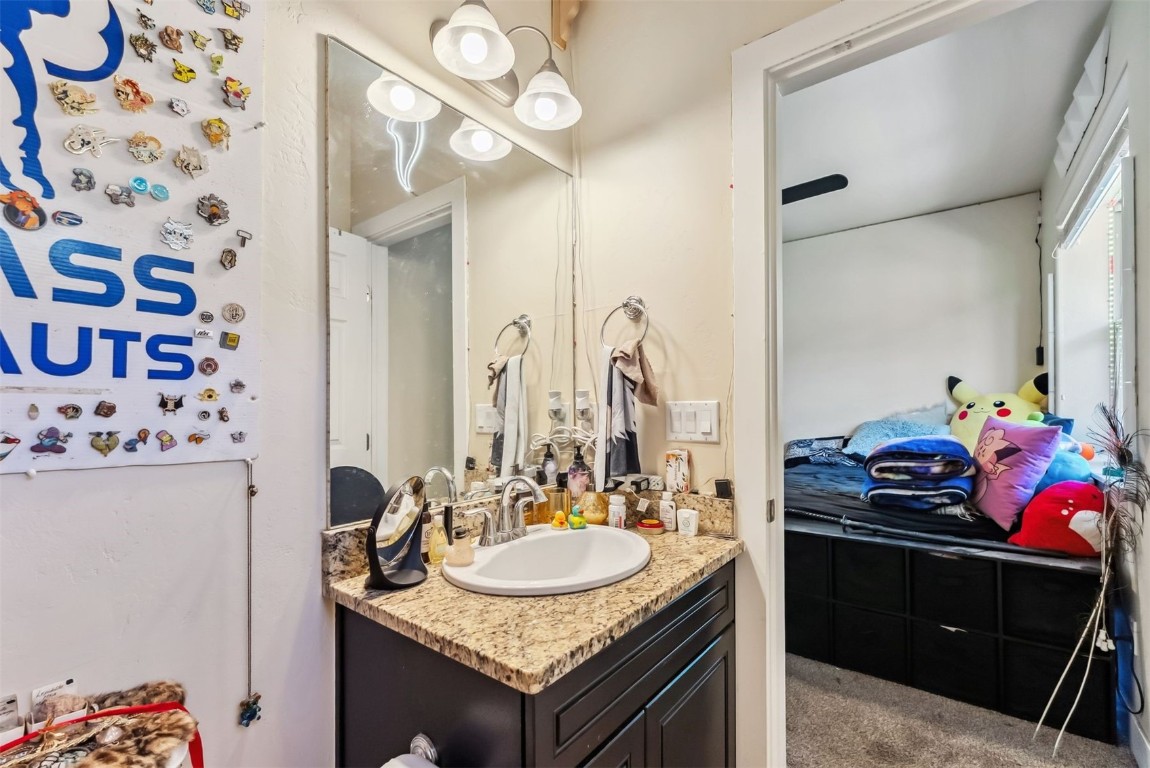32 Wayback Drive, Unit 32 Keystone, CO 80435 - Photo 27 of 28 a bathroom with a granite countertop sink a vanity and a mirror