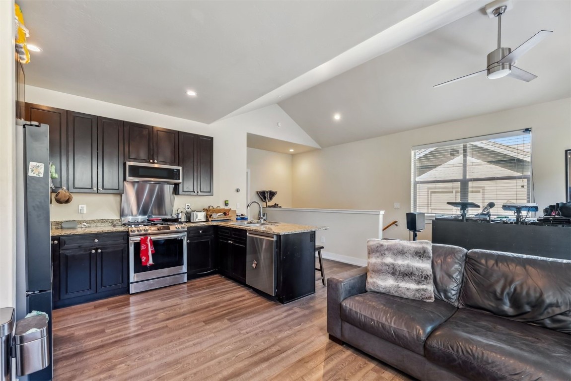 32 Wayback Drive, Unit 32 Keystone, CO 80435 - Photo 6 of 28 a large kitchen with kitchen island granite countertop wooden floors stainless steel appliances and a window