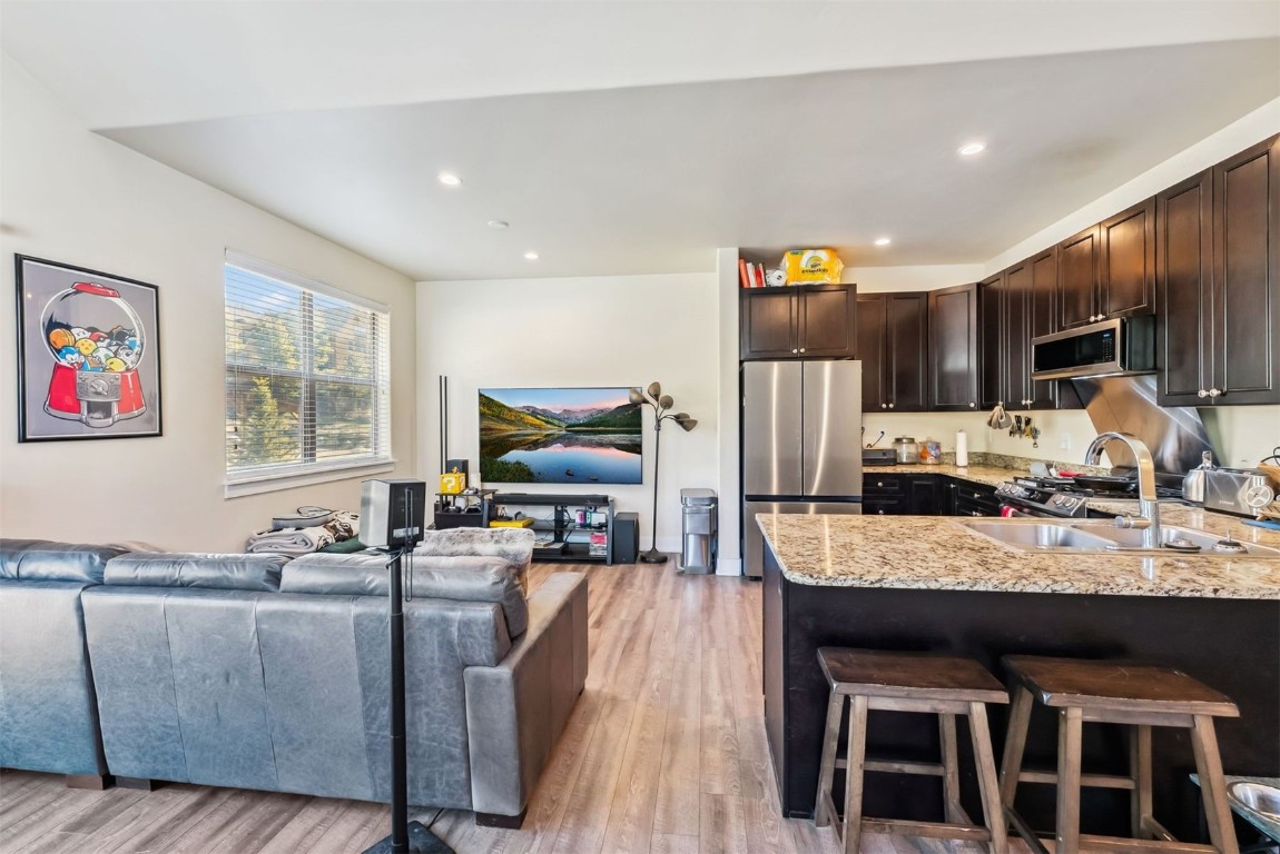 32 Wayback Drive, Unit 32 Keystone, CO 80435 - Photo 7 of 28 a living room with stainless steel appliances kitchen island granite countertop a table chairs and a refrigerator