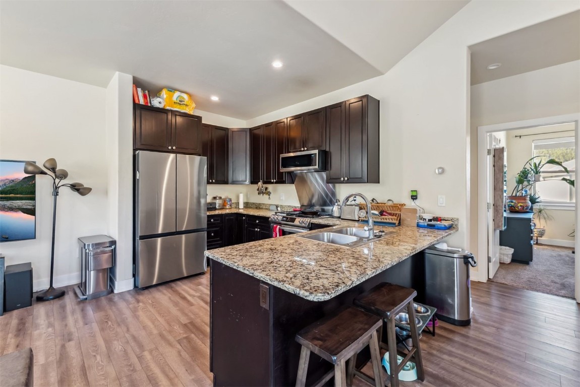32 Wayback Drive, Unit 32 Keystone, CO 80435 - Photo 8 of 28 a kitchen with a refrigerator a stove a sink a dining table and chairs
