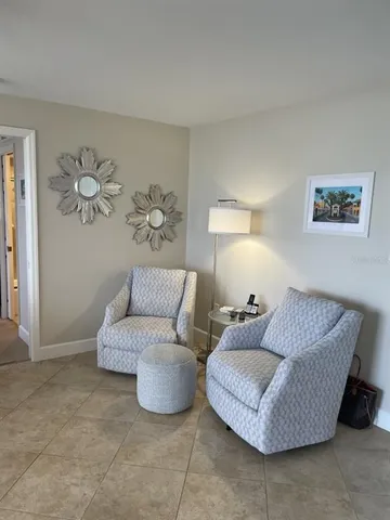 a bedroom with a bed and a flat tv screen on dresser
