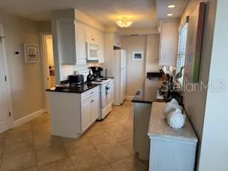 a bathroom with a granite countertop toilet sink and mirror