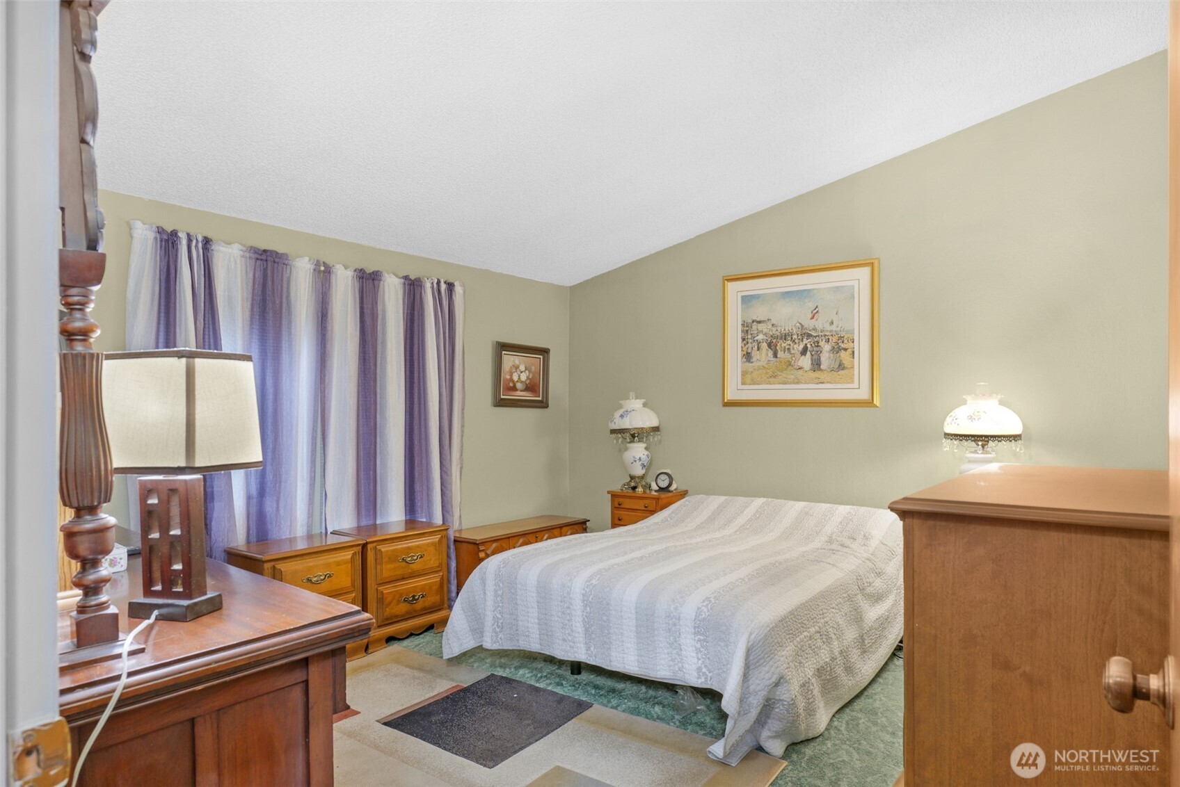 6217 4th Street East Tacoma, WA 98424 - Photo 15 of 40 a bedroom with a bed and a dresser next to a window