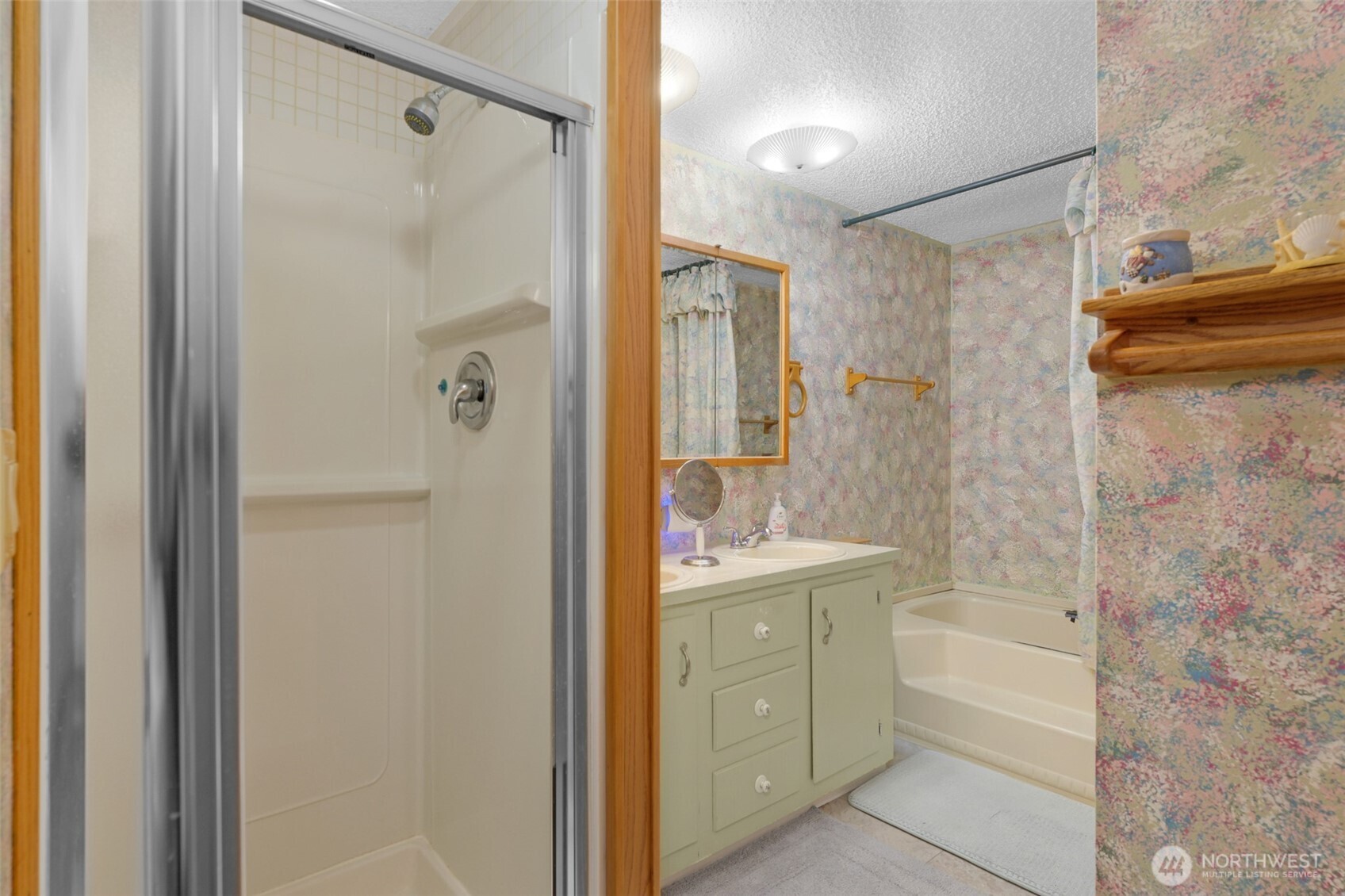 6217 4th Street East Tacoma, WA 98424 - Photo 17 of 40 a bathroom with a shower a sink and a mirror