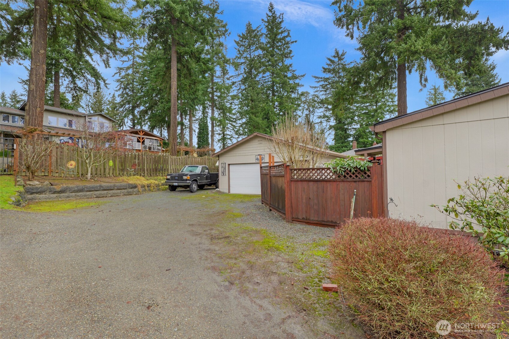 6217 4th Street East Tacoma, WA 98424 - Photo 3 of 40 a view of a house with a yard and covered with wooden fence