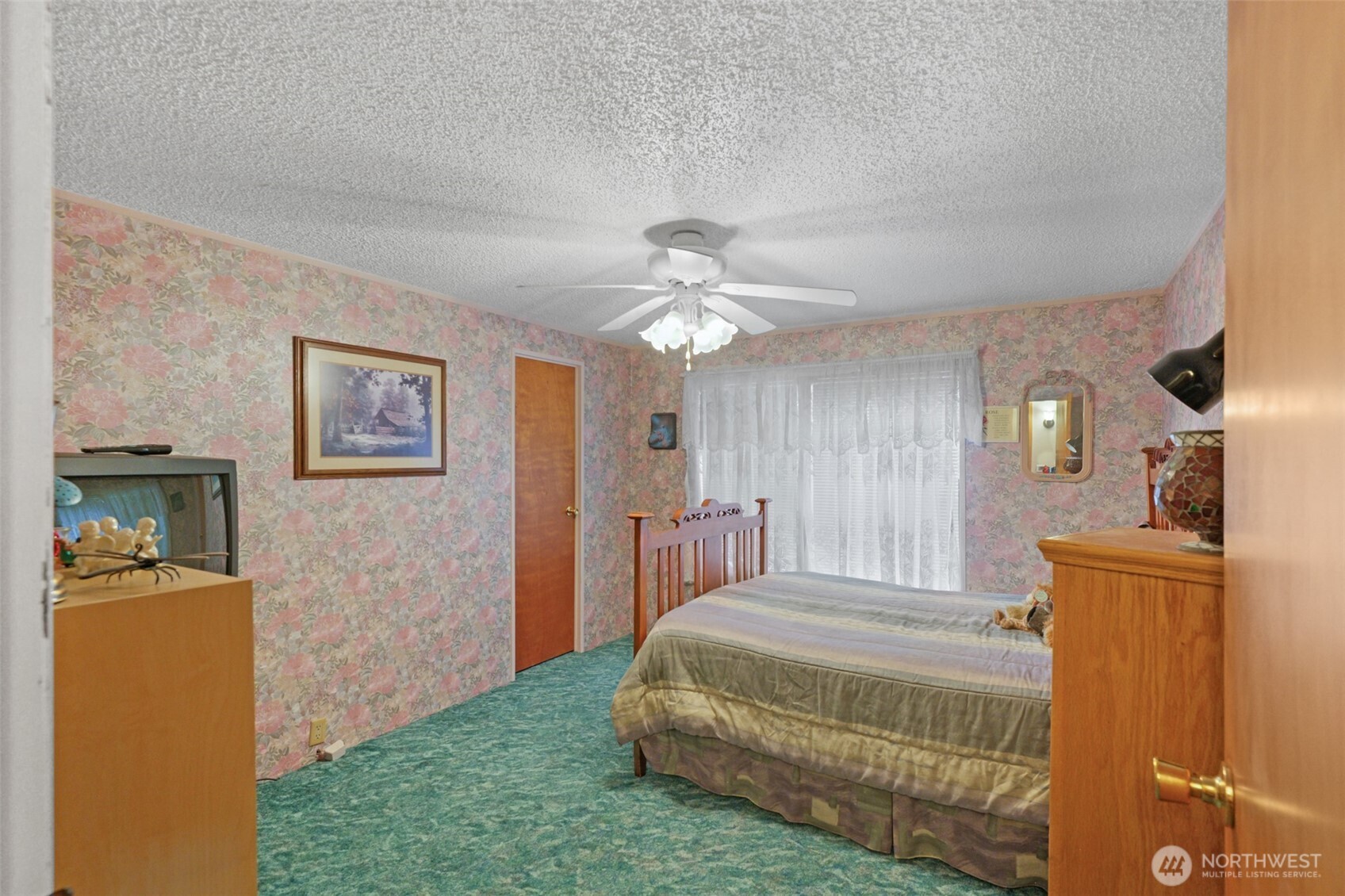 6217 4th Street East Tacoma, WA 98424 - Photo 31 of 40 a bedroom with a bed and a chandelier