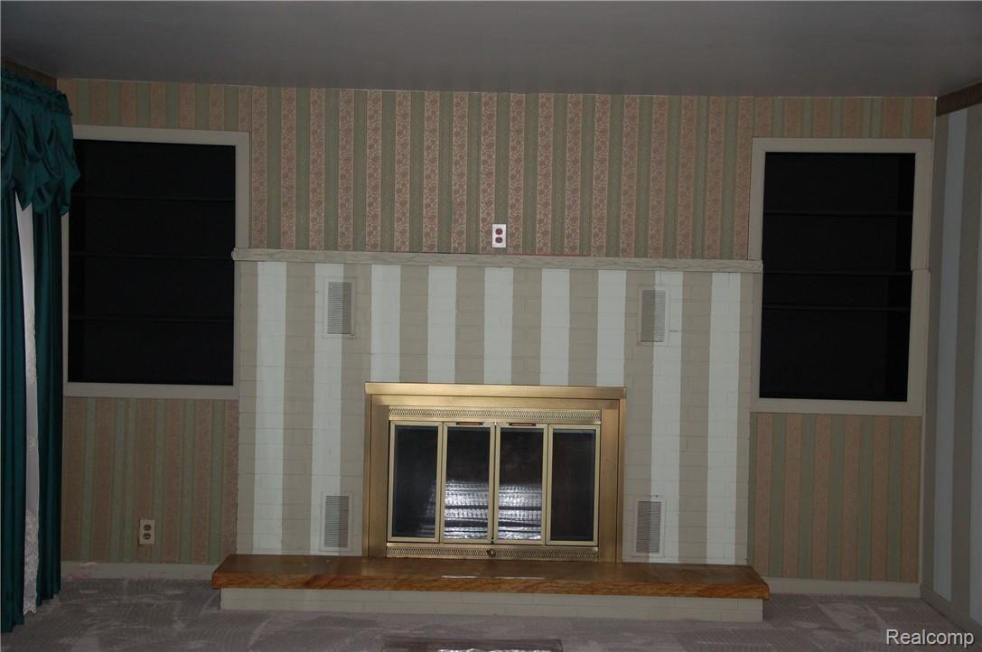 2043 Covert Road Burton, MI 48509 - Photo 11 of 32 Fireplace in extra room 2043 Covert Road