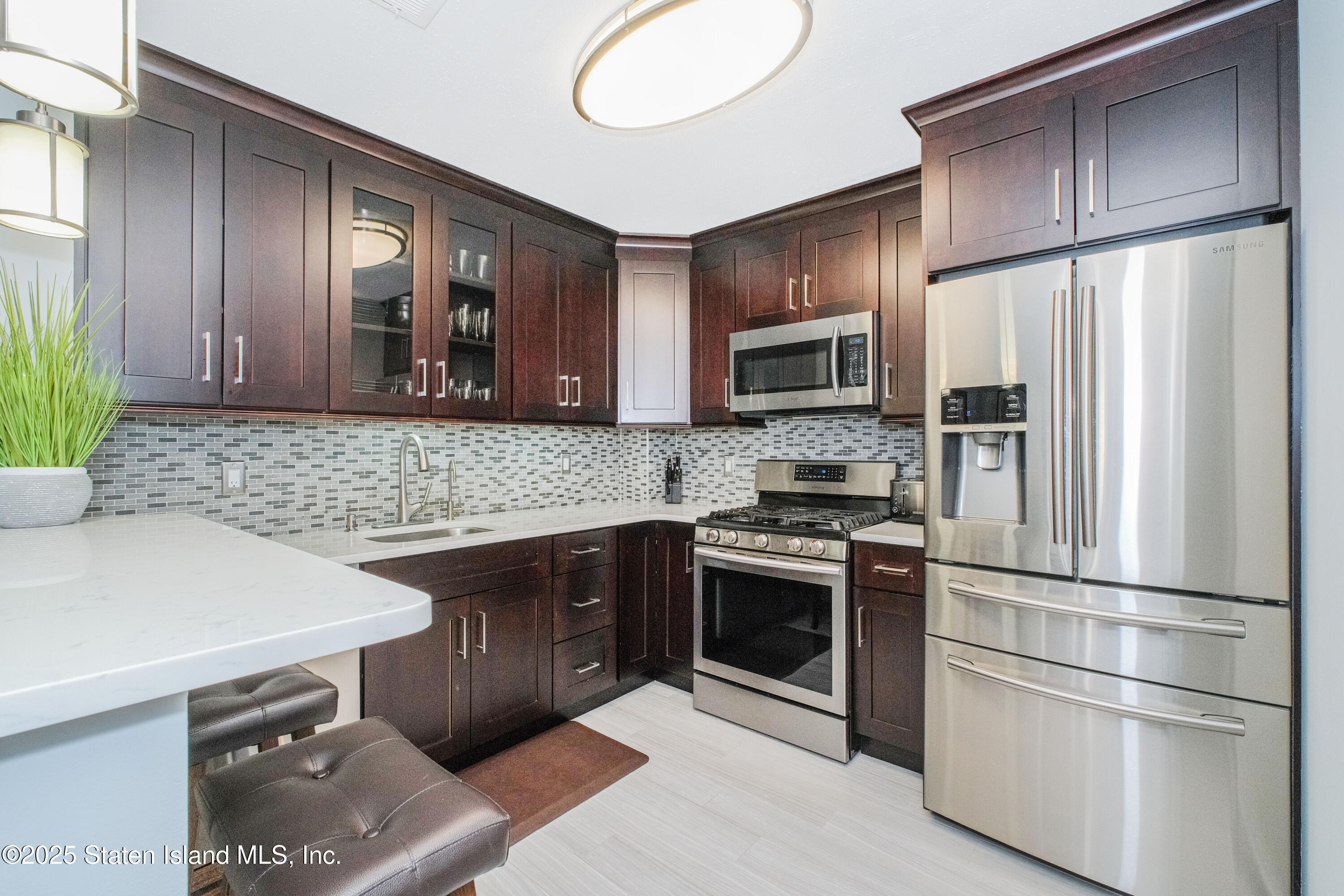 217 Jamie Lane Staten Island, NY 10312 - Photo 14 of 29 a kitchen with granite countertop stainless steel appliances a stove sink and microwave