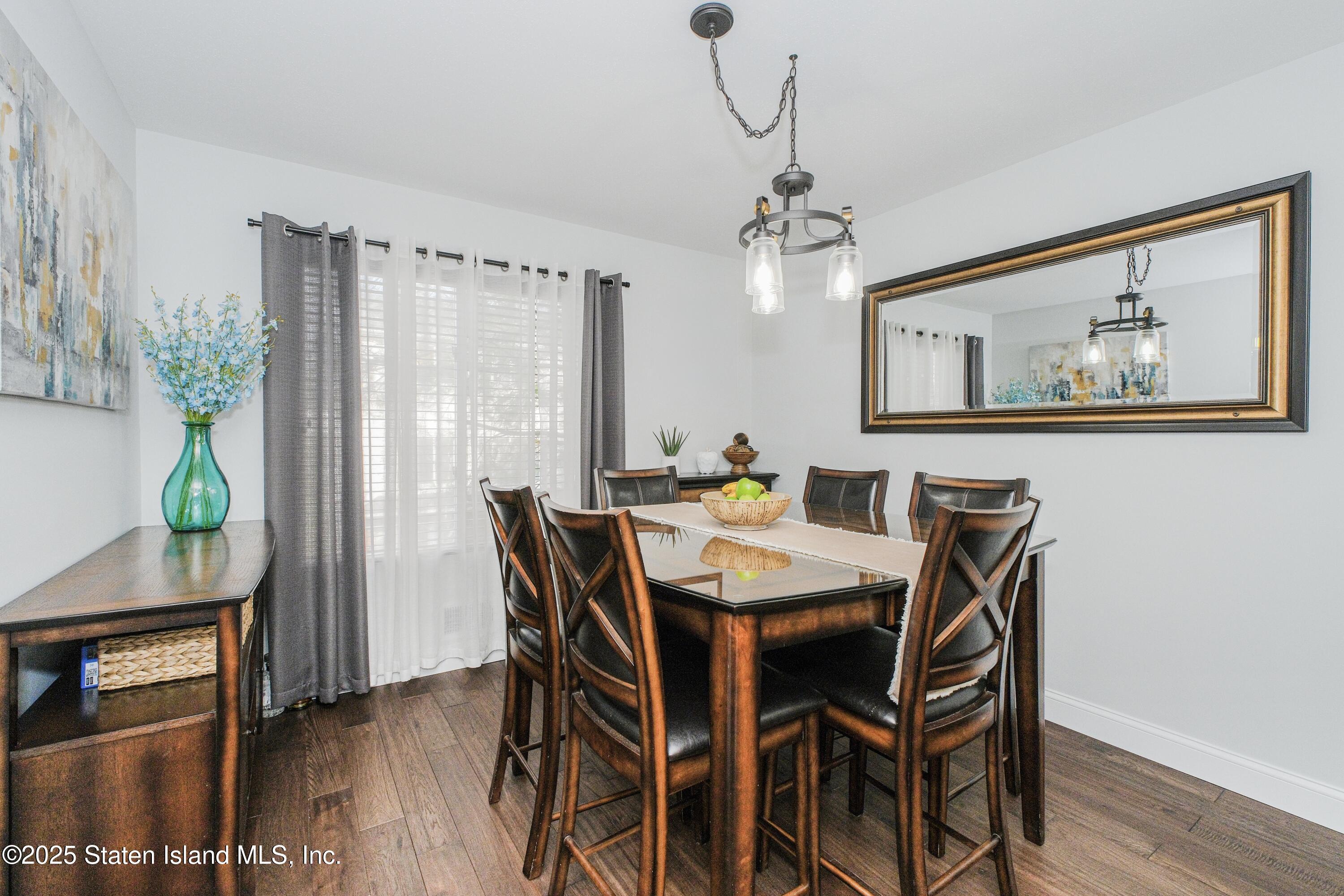 217 Jamie Lane Staten Island, NY 10312 - Photo 16 of 29 a view of a dining room with furniture window and wooden floor