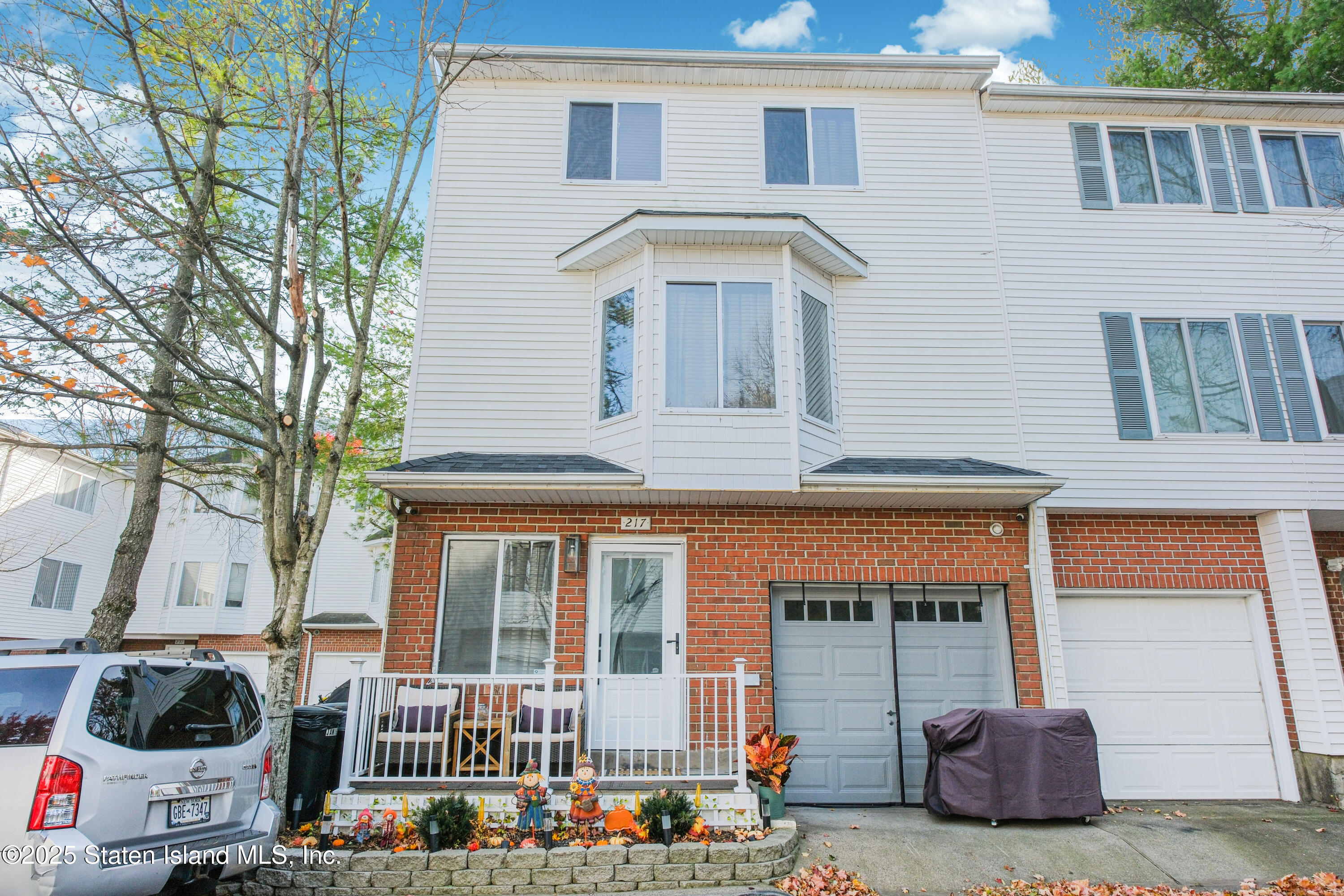 217 Jamie Lane Staten Island, NY 10312 - Photo 2 of 29 a front view of a house with large windows