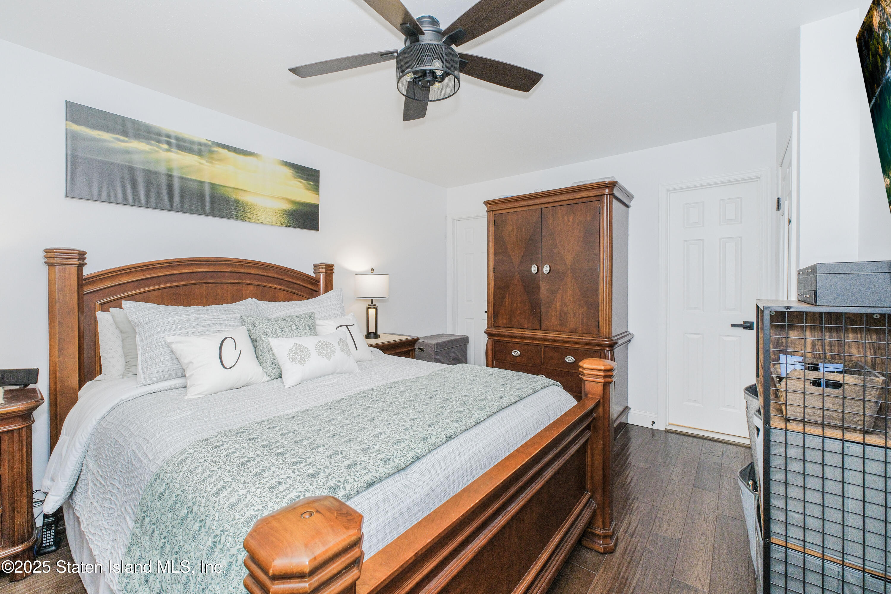 217 Jamie Lane Staten Island, NY 10312 - Photo 21 of 29 a bedroom with a bed and wooden floor