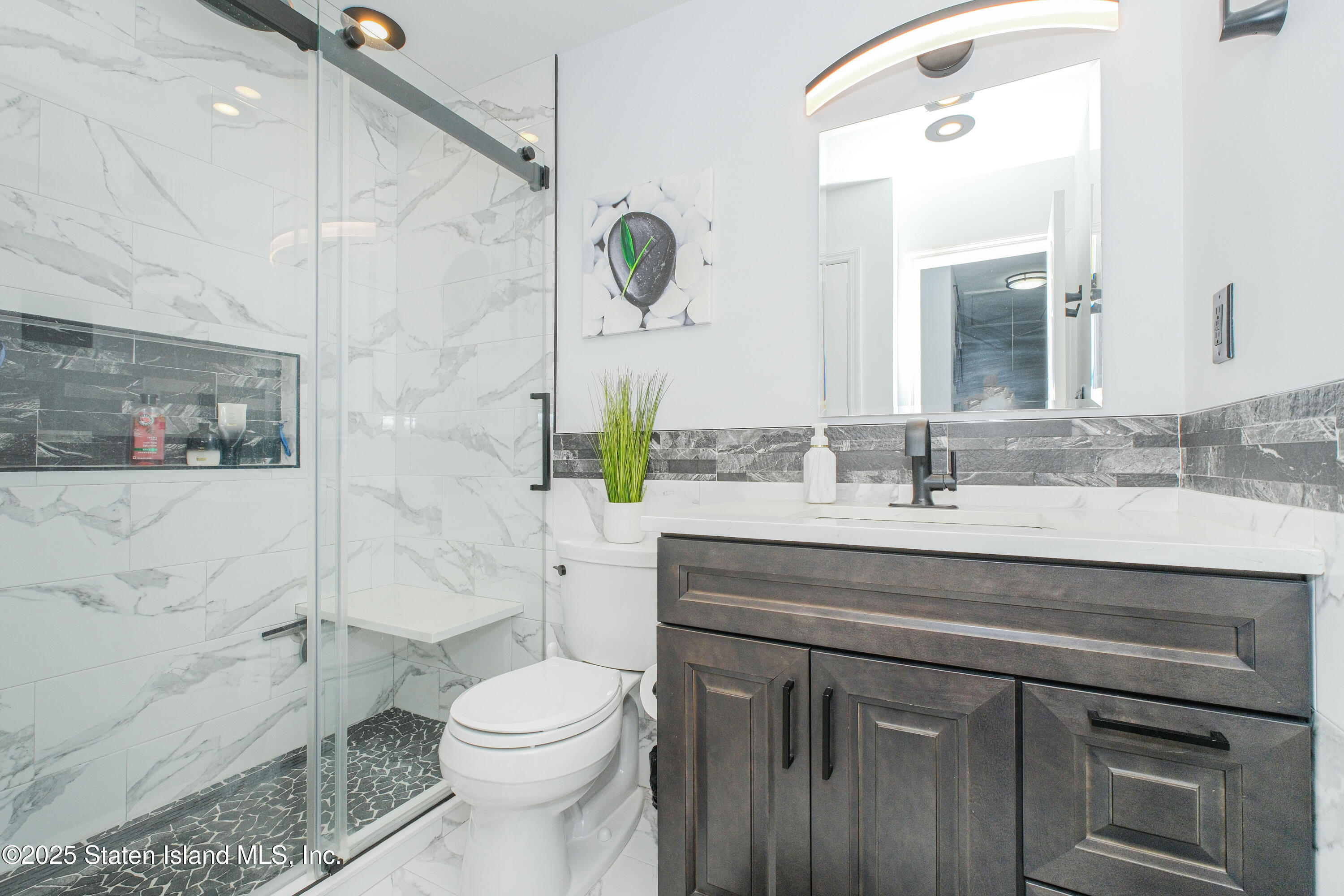 217 Jamie Lane Staten Island, NY 10312 - Photo 22 of 29 a bathroom with a sink a toilet and shower