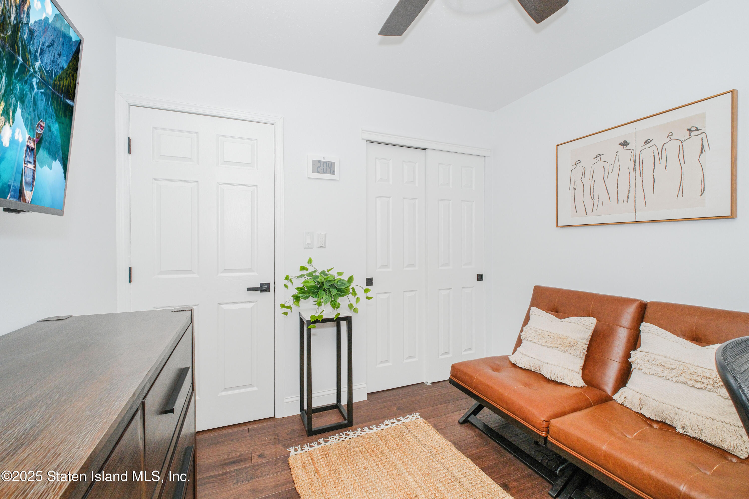 217 Jamie Lane Staten Island, NY 10312 - Photo 25 of 29 a living room with furniture flowerpot and wooden floor