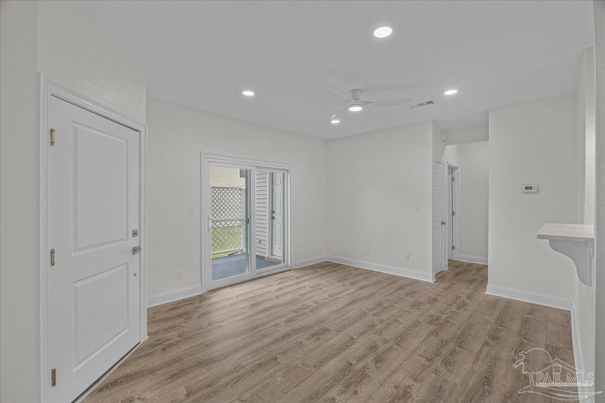 601 East Burgess Road, Unit C3 Pensacola, FL 32504 - Photo 15 of 35 a view of an empty room with wooden floor