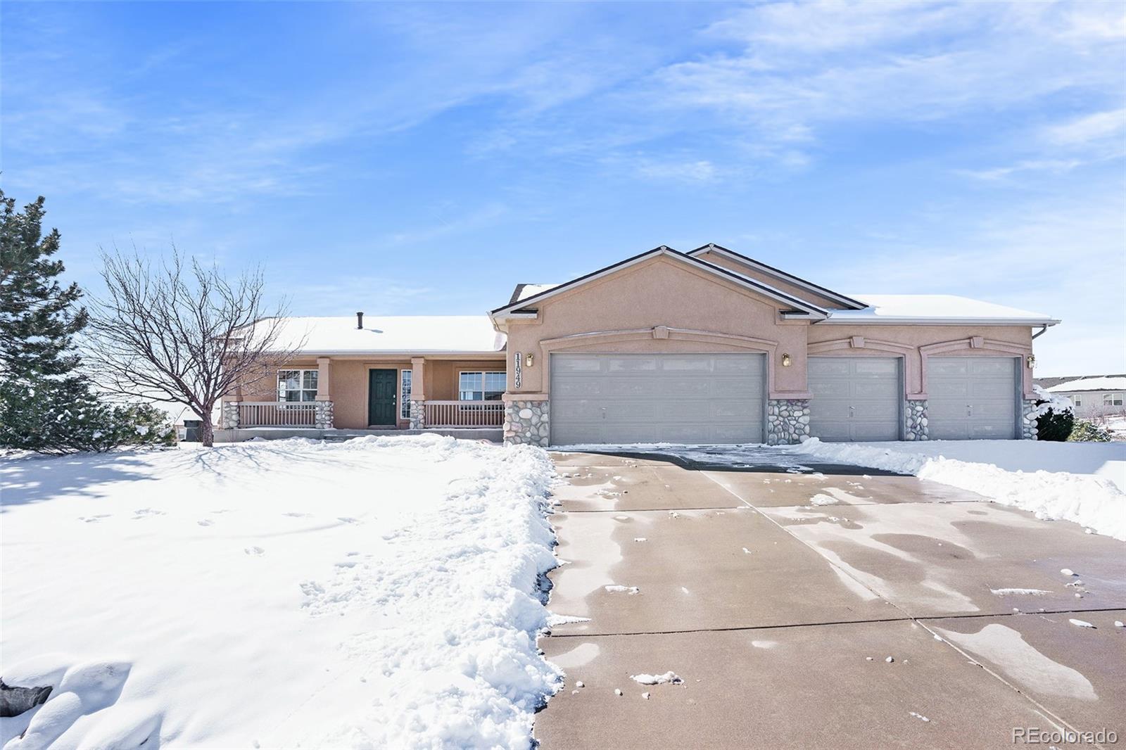 11949 Rio Secco Road Peyton, CO 80831 - Photo 1 of 19 a front view of a house with a yard