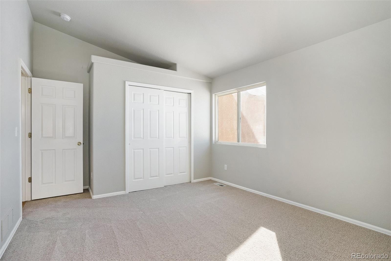 11949 Rio Secco Road Peyton, CO 80831 - Photo 12 of 19 an empty room with windows