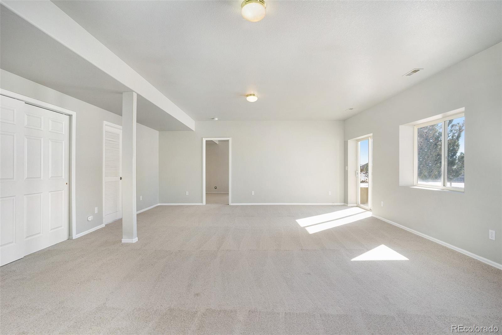 11949 Rio Secco Road Peyton, CO 80831 - Photo 14 of 19 a view of an empty room with a window