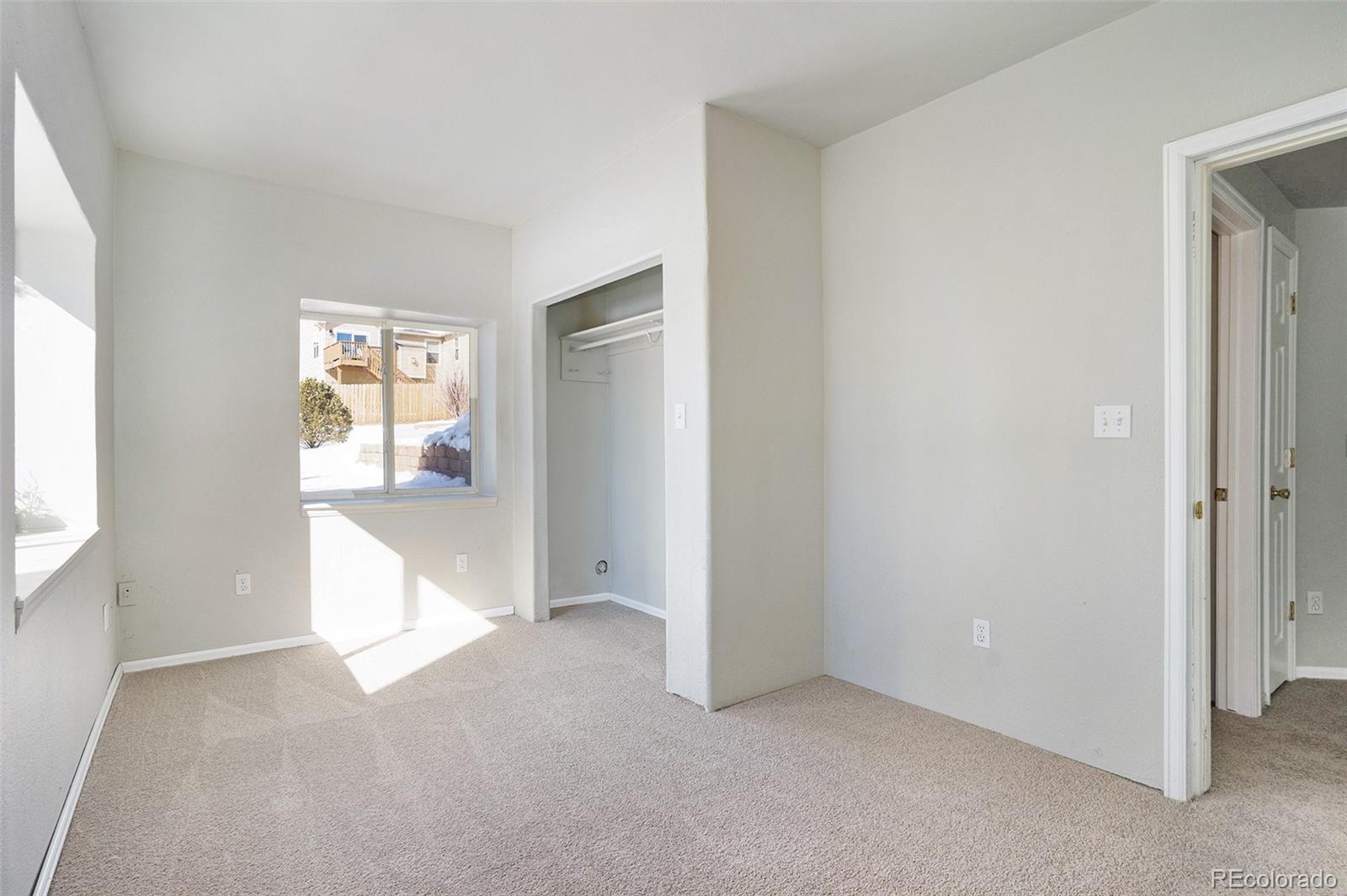 11949 Rio Secco Road Peyton, CO 80831 - Photo 16 of 19 an empty room with windows