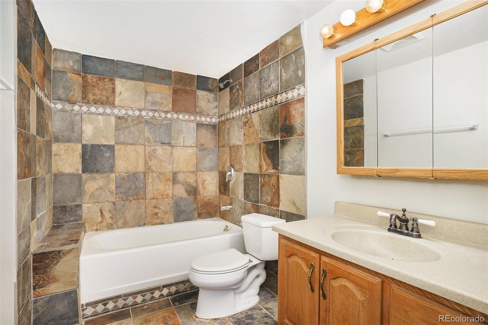 11949 Rio Secco Road Peyton, CO 80831 - Photo 18 of 19 a bathroom with a sink a toilet and a bathtub