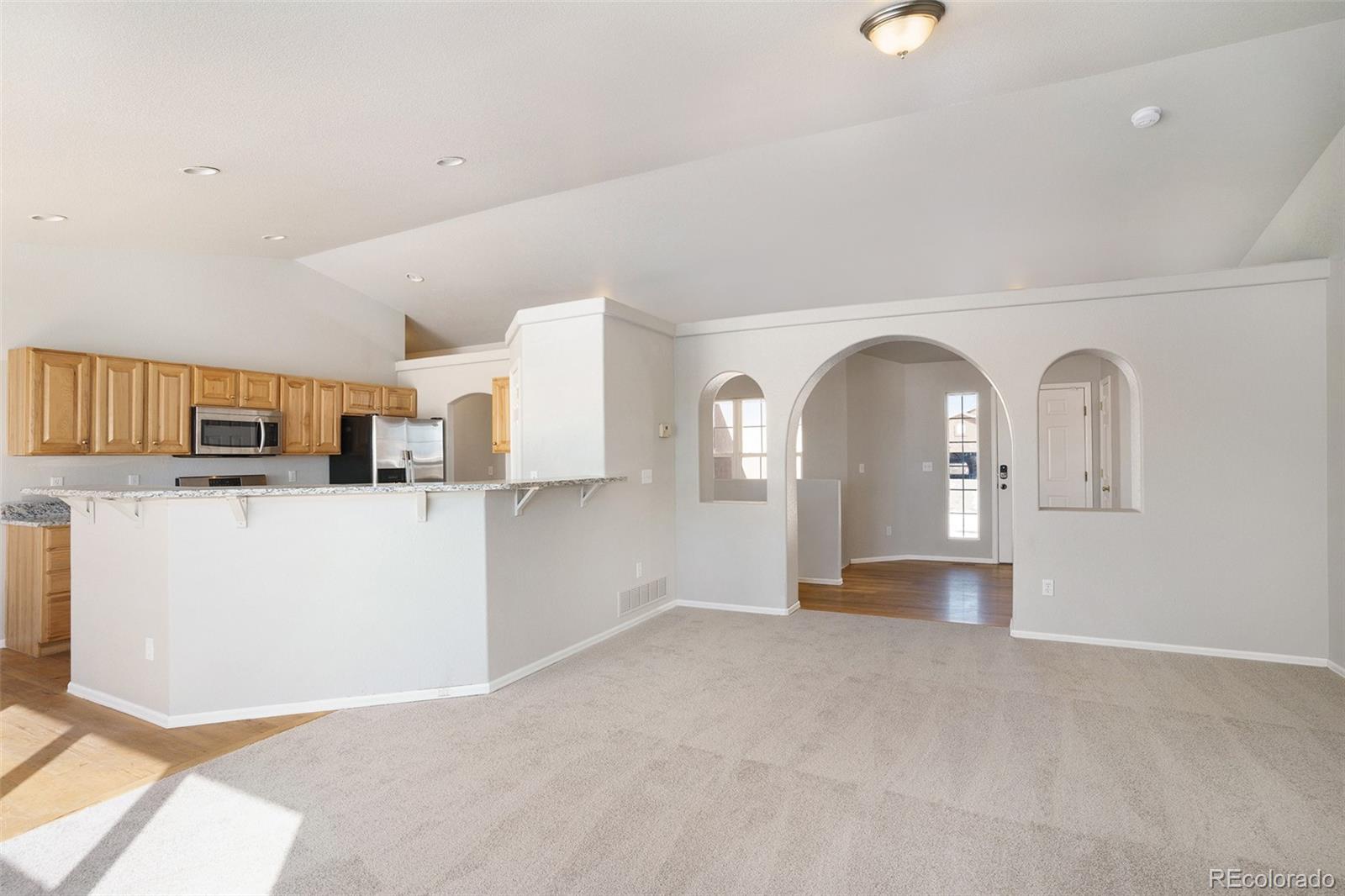 11949 Rio Secco Road Peyton, CO 80831 - Photo 9 of 19 a view of a kitchen with furniture and floor to ceiling window