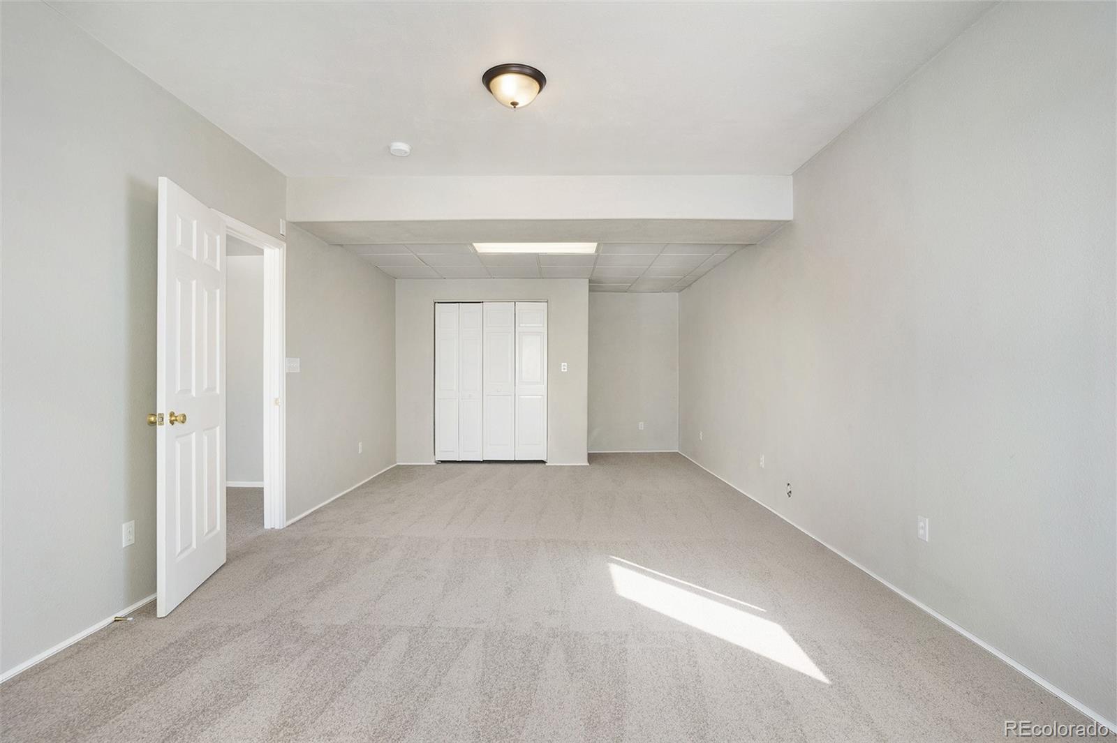 11949 Rio Secco Road Peyton, CO 80831 - Photo 10 of 19 an empty room with windows